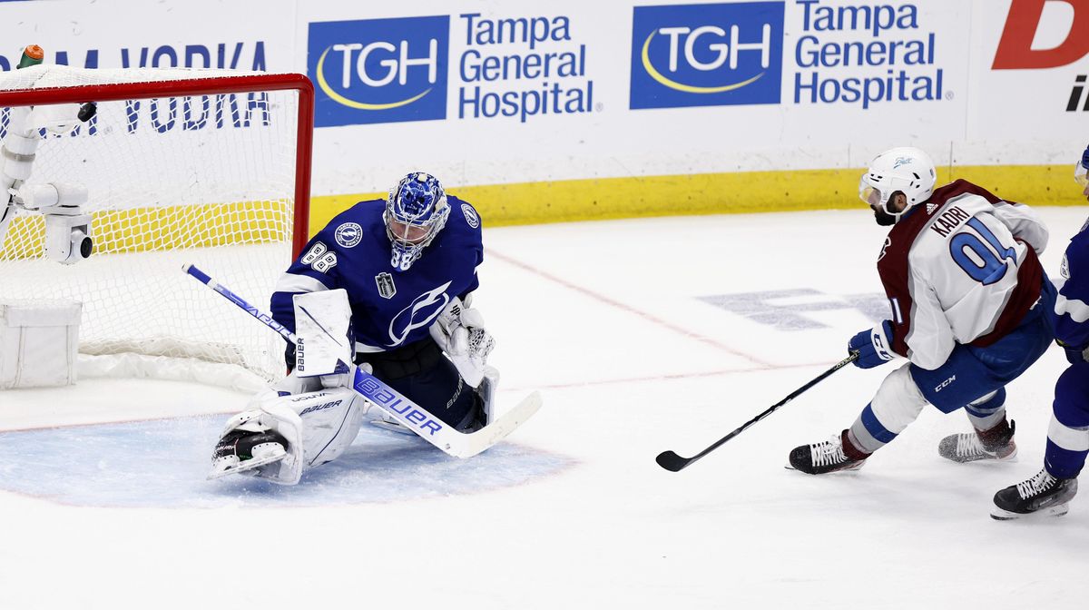 Nazem Kadri of the Colorado Avalanche scores a goal against Andrei Vasilevskiy of the Tampa Bay Lightning to win 3-2 in overtime in Game Four of the 2022 NHL Stanley Cup Final.
