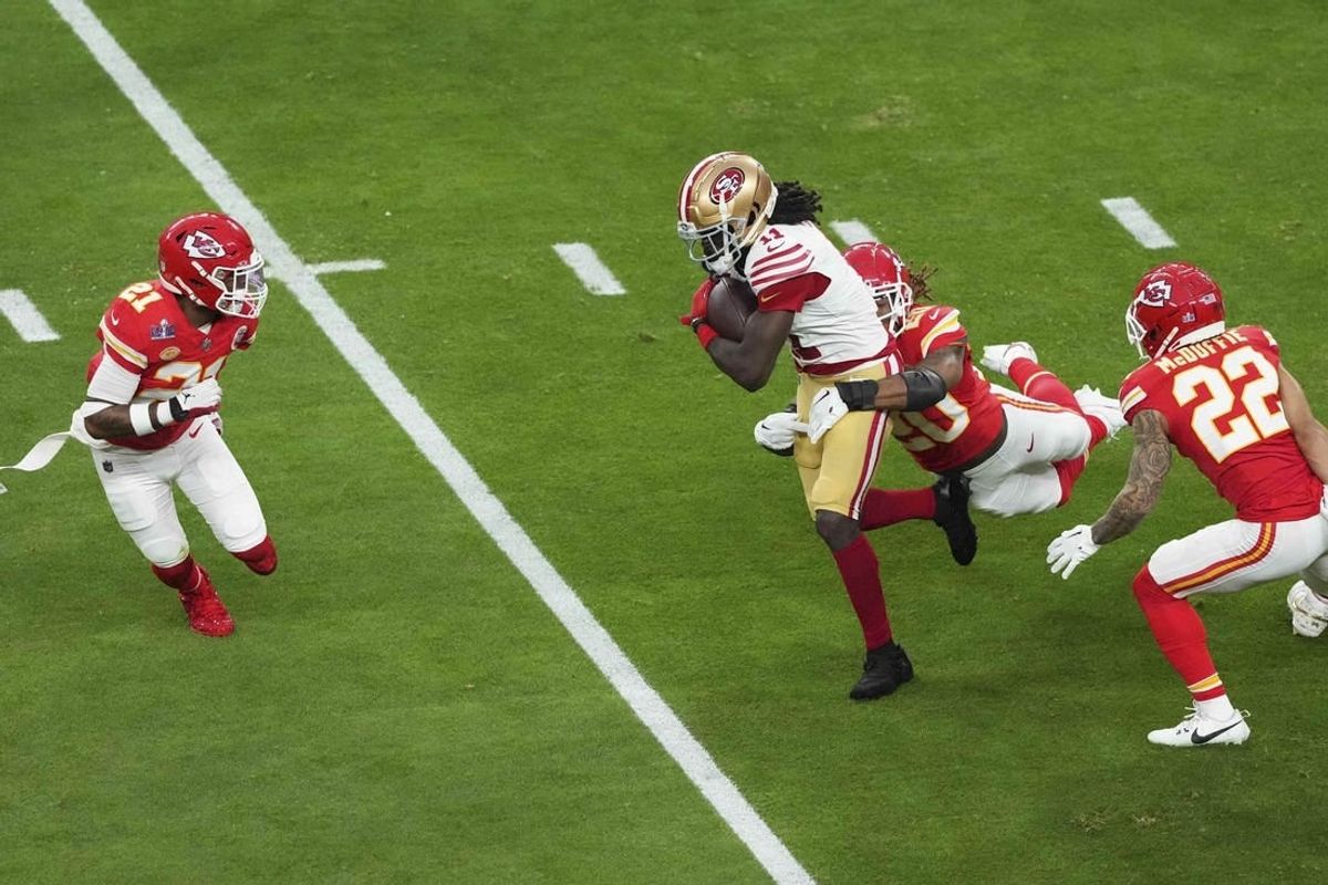 Feb 11, 2024; Paradise, Nevada, USA;  San Francisco 49ers wide receiver Brandon Aiyuk (11) runs with the ball as Kansas City Chiefs safety Justin Reid (20) defends during the first quarter of Super Bowl LVIII at Allegiant Stadium.