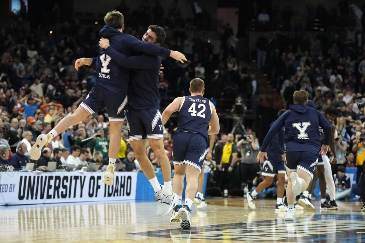 Mar 22, 2024; Spokane, WA, USA; Yale Bulldogs guard Trevor Mullin (0) celebrates with guard Emir Buyukhanli (11) after a game against the Auburn Tigers in the first round of the 2024 NCAA Tournament at Spokane Veterans Memorial Arena.