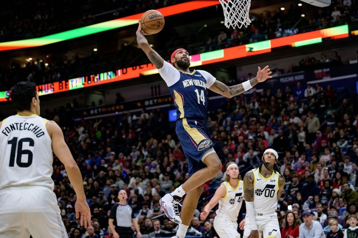 Dec 28, 2023; New Orleans, Louisiana, USA; New Orleans Pelicans forward Brandon Ingram (14) dunks against Utah Jazz guard Jordan Clarkson (00) during the first quarter at the Smoothie King Center.