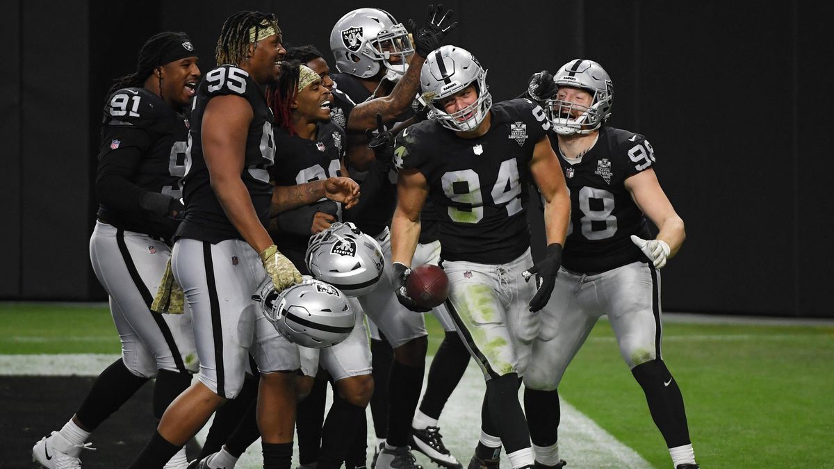 Defensive end Carl Nassib, who recently came out, celebrates with Raiders teammates after he intercepted a Denver Broncos’ pass in the second half of their game at Allegiant Stadium on November 15, 2020, in Las Vegas.
