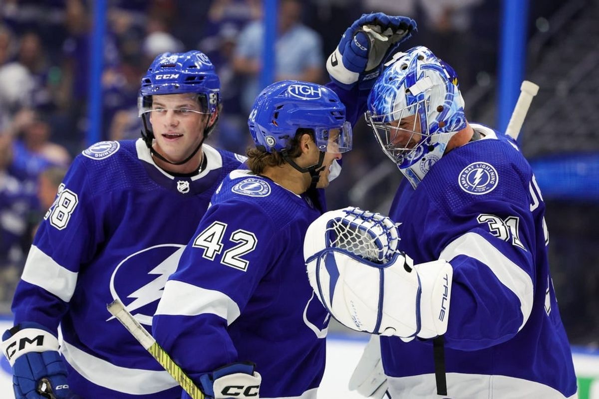 Sep 29, 2023; Tampa, Florida, USA;  Tampa Bay Lightning goaltender Jonas Johansson (31) is congratulated by Tampa Bay Lightning center Felix Robert (42) and defenseman Jack Thompson (28) after beating the Carolina Hurricanes during preseason at Amalie Arena.