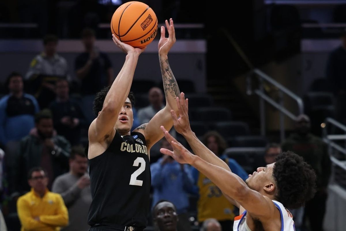 Mar 22, 2024; Indianapolis, IN, USA; Colorado Buffaloes guard KJ Simpson (2) shoots against Florida Gators guard Zyon Pullin (0) in the second half in the first round of the 2024 NCAA Tournament at Gainbridge FieldHouse.