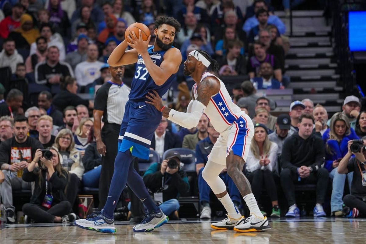 Nov 22, 2023; Minneapolis, Minnesota, USA; Philadelphia 76ers forward Robert Covington (33) defends Minnesota Timberwolves center Karl-Anthony Towns (32) in the second quarter at Target Center.