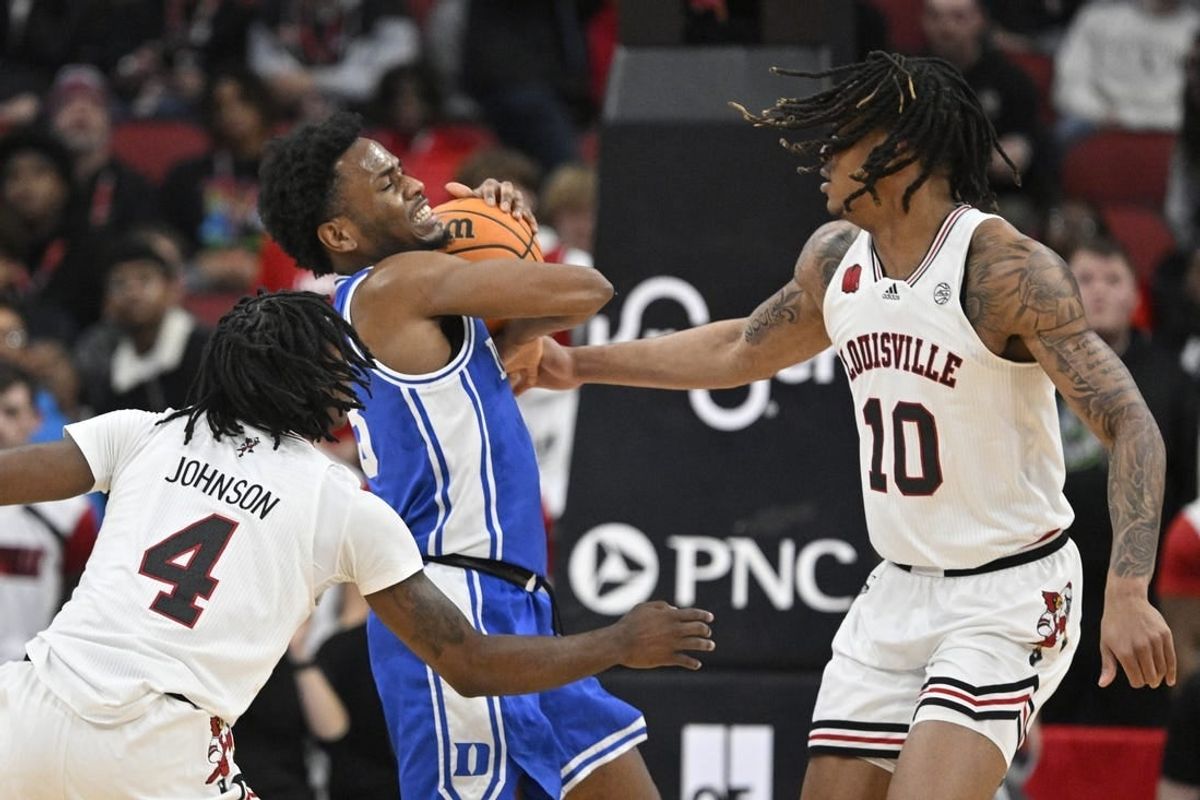 Jan 23, 2024; Louisville, Kentucky, USA;  Duke Blue Devils guard Jeremy Roach (3) battles Louisville Cardinals forward Kaleb Glenn (10) and guard Ty-Laur Johnson (4) during the first half at KFC Yum! Center.