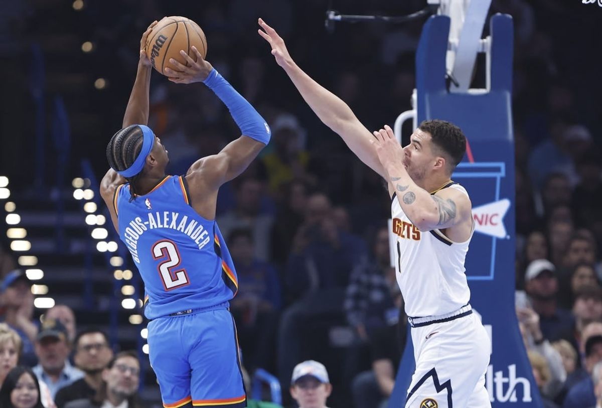 Jan 31, 2024; Oklahoma City, Oklahoma, USA; Oklahoma City Thunder guard Shai Gilgeous-Alexander (2) shoots as Denver Nuggets forward Michael Porter Jr. (1) defends during the first quarter at Paycom Center.