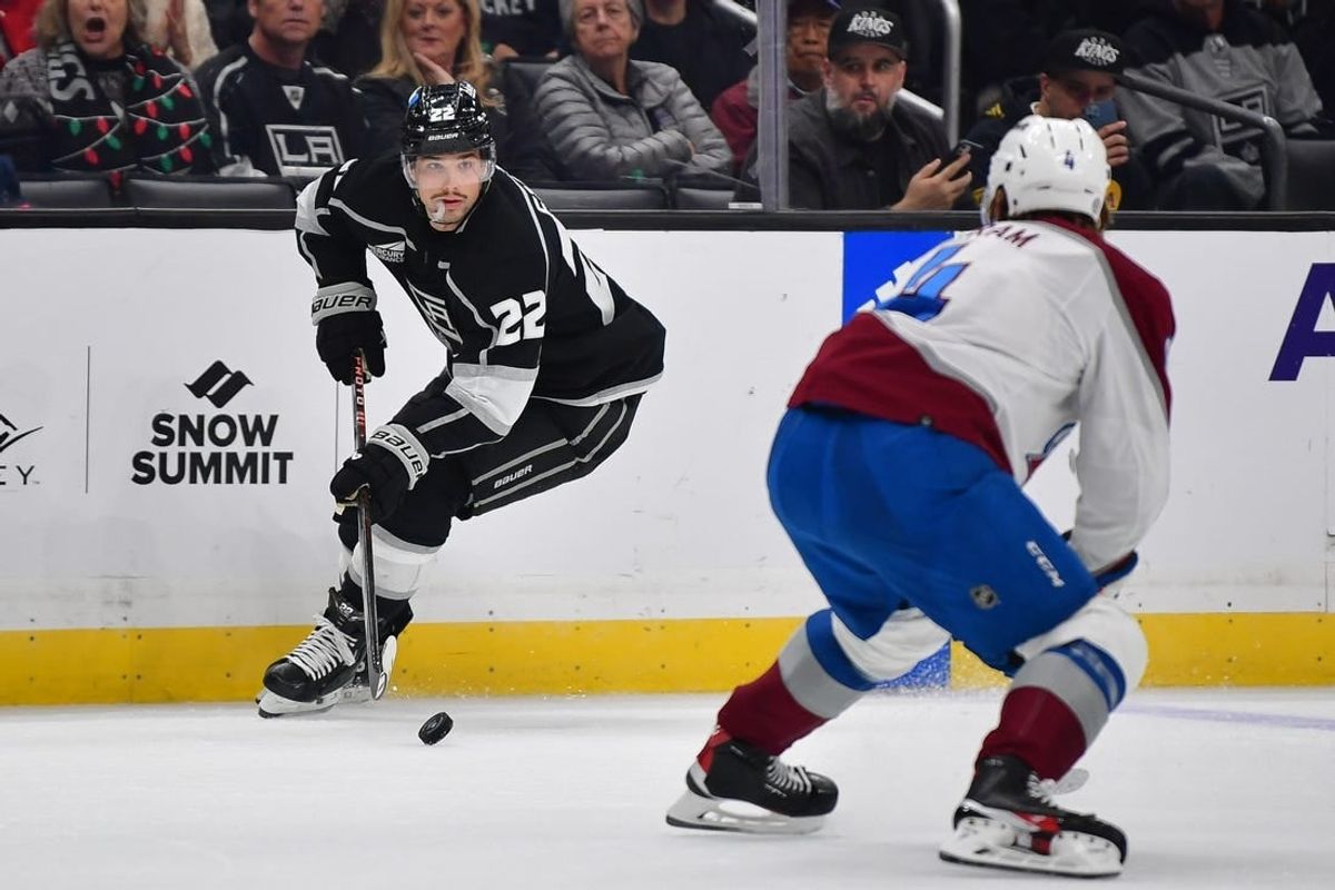 Dec 3, 2023; Los Angeles, California, USA; Los Angeles Kings left wing Kevin Fiala (22) moves the puck against Colorado Avalanche defenseman Bowen Byram (4) during the second period at Crypto.com Arena.