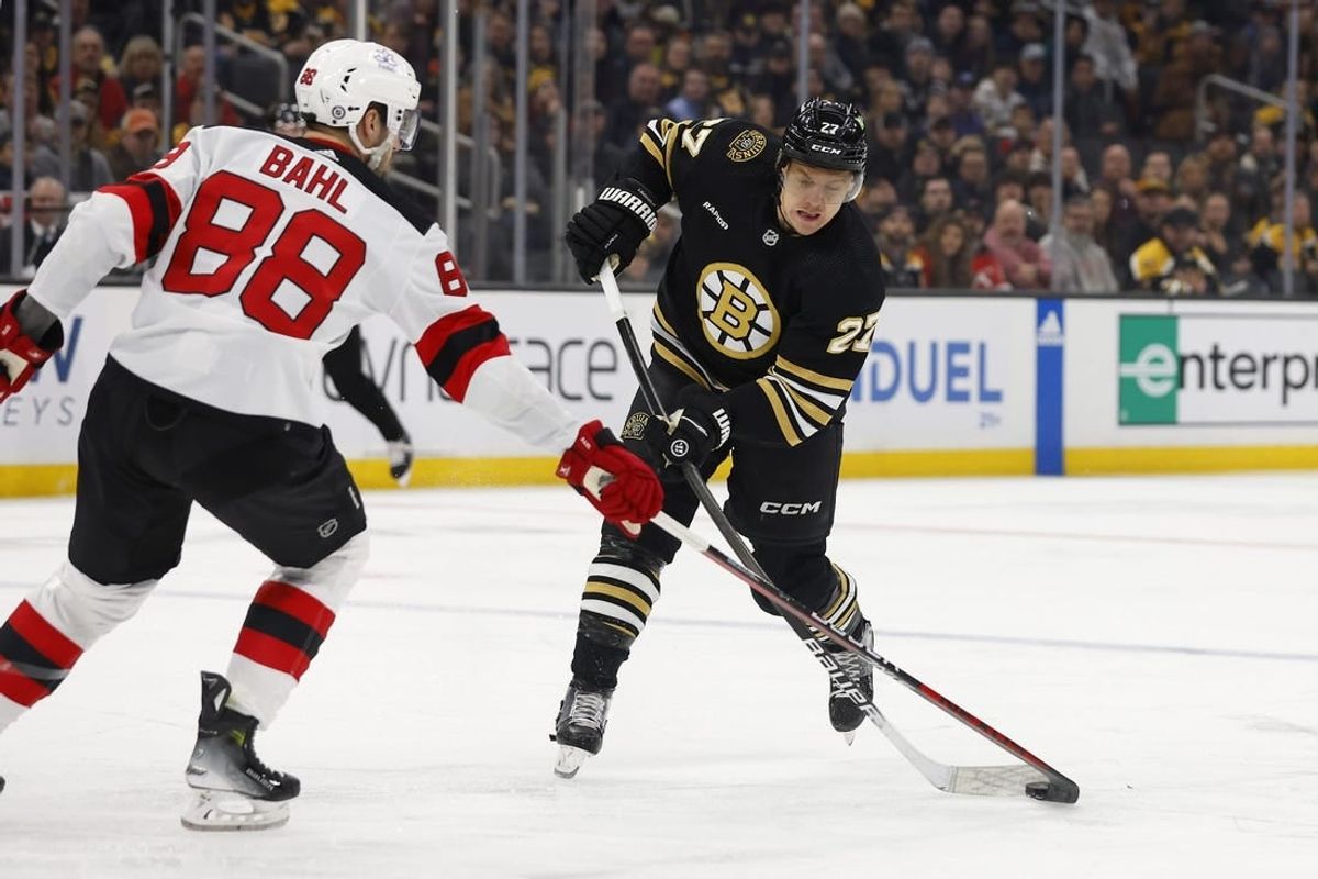 Jan 15, 2024; Boston, Massachusetts, USA; New Jersey Devils defenseman Kevin Bahl (88) gets his stick on a shot by Boston Bruins defenseman Hampus Lindholm (27) during the first period at TD Garden.