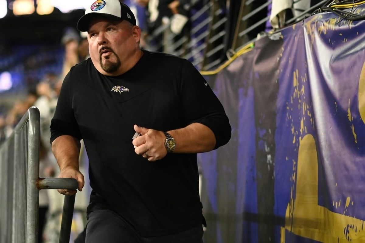 Oct 9, 2022; Baltimore, Maryland, USA;  Baltimore Ravens offensive coordinator Greg Roman runs on the field  before the game against the Cincinnati Bengals at M&T Bank Stadium.