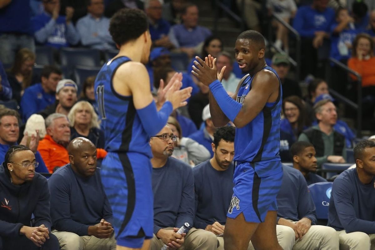 Dec 19, 2023; Memphis, Tennessee, USA; Memphis Tigers guard Jahvon Quinerly (11) and forward David Jones (8) react during the second half against the Virginia Cavaliers at FedExForum.