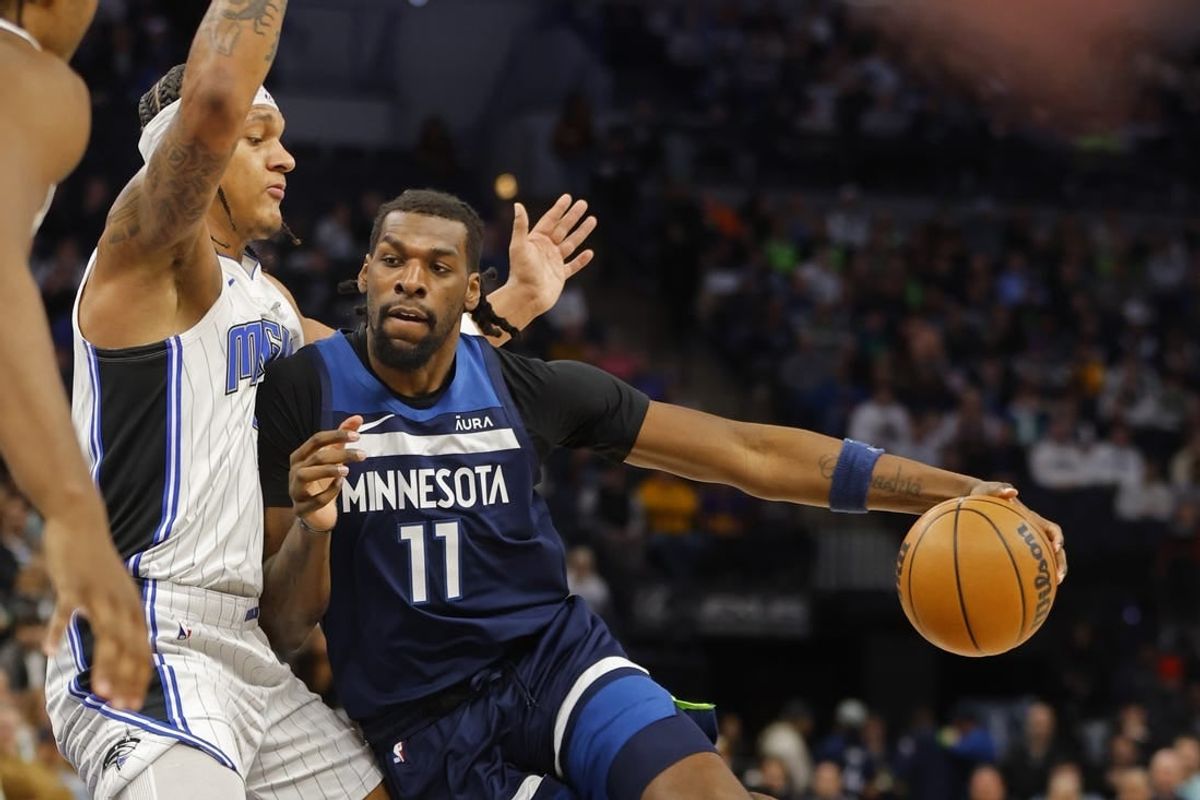 Feb 2, 2024; Minneapolis, Minnesota, USA; Minnesota Timberwolves center Naz Reid (11) works around Orlando Magic forward Paolo Banchero (5) in the first quarter at Target Center.