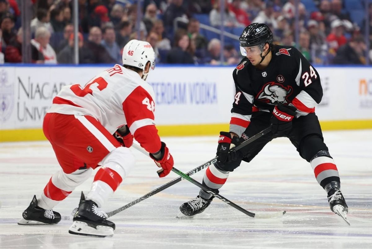 Mar 12, 2024; Buffalo, New York, USA;  Buffalo Sabres center Dylan Cozens (24) carries the puck up ice as Detroit Red Wings defenseman Jeff Petry (46) defends during the second period at KeyBank Center.