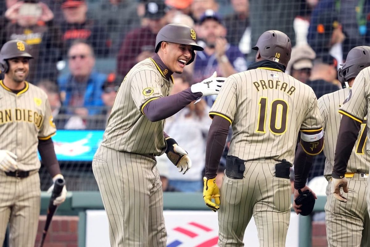 Apr 6, 2024; San Francisco, California, USA; San Diego Padres left fielder Jurickson Profar (10) is congratulated by designated hitter Manny Machado (center left) after hitting a grand slam home run against the San Francisco Giants during the first inning at Oracle Park.