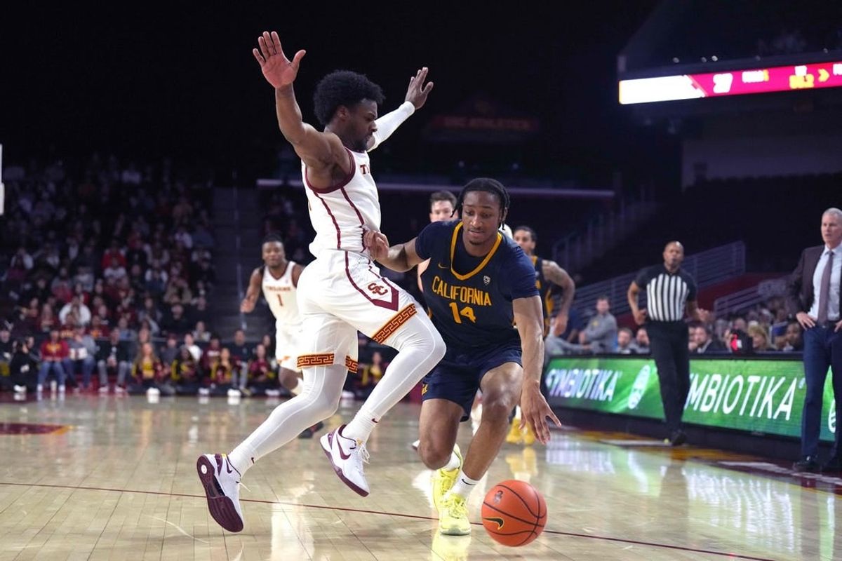 Jan 3, 2024; Los Angeles, California, USA; California Golden Bears forward Grant Newell (14) dribbles against Southern California Trojans guard Bronny James (6)  in the first half at Galen Center.