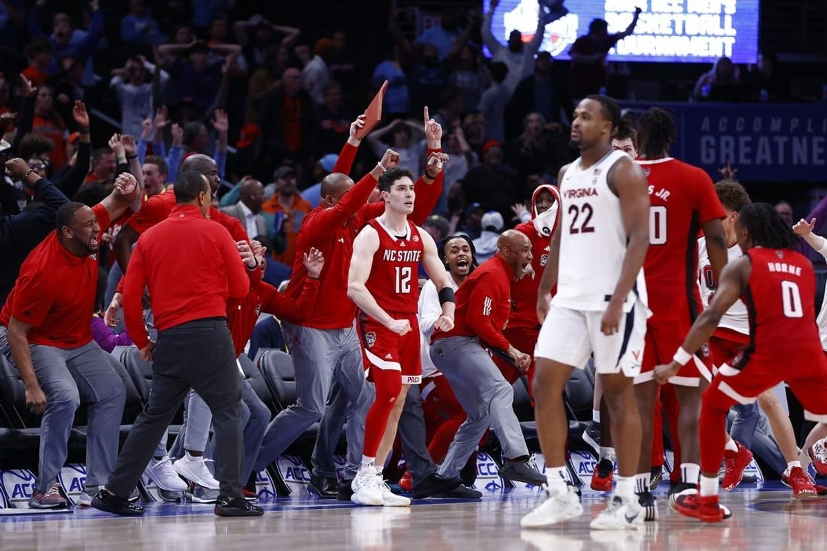 Mar 15, 2024; Washington, D.C., USA; North Carolina State Wolfpack guard Michael O'Connell (12) celebrates after shooting a three point shot at the buzzer during the second half against the Virginia Cavaliers at Capital One Arena.