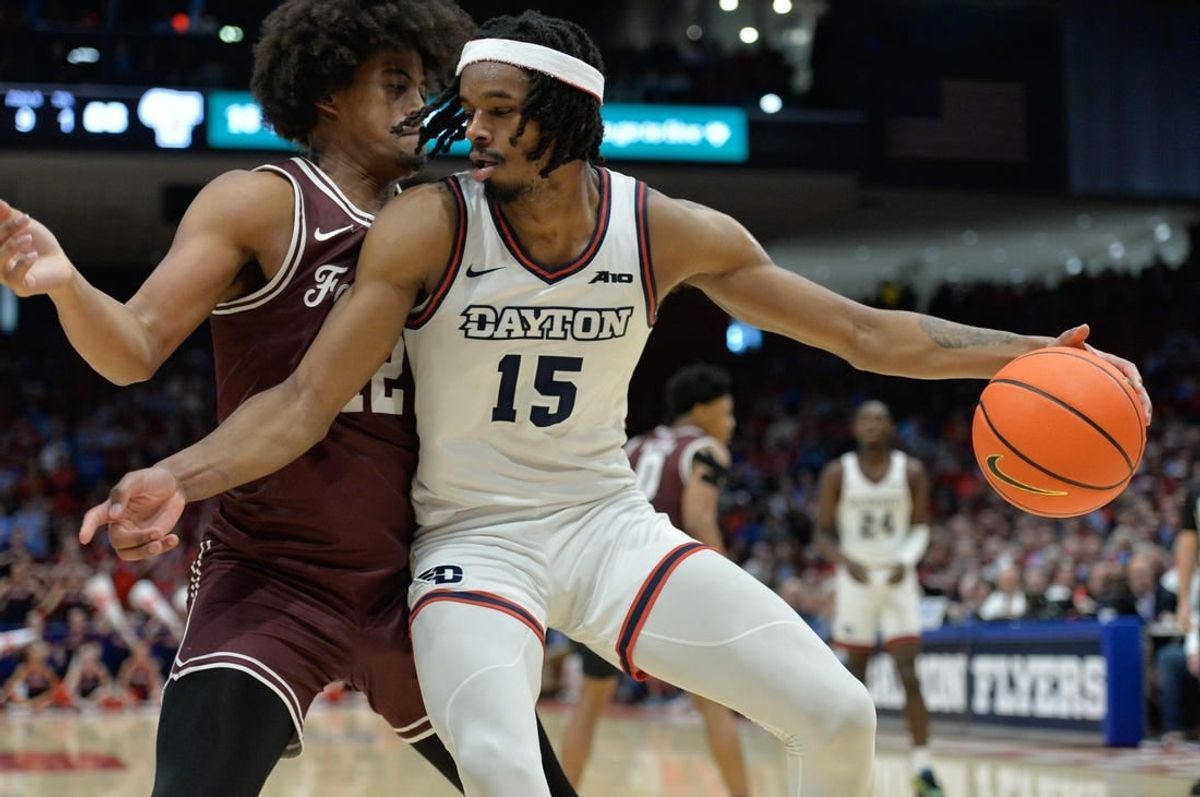 Feb 17, 2024; Dayton, Ohio, USA;  Dayton Flyers forward DaRon Holmes II (15) is fouled by Fordham Rams forward Elijah Gray (12) during a game at University of Dayton Arena.