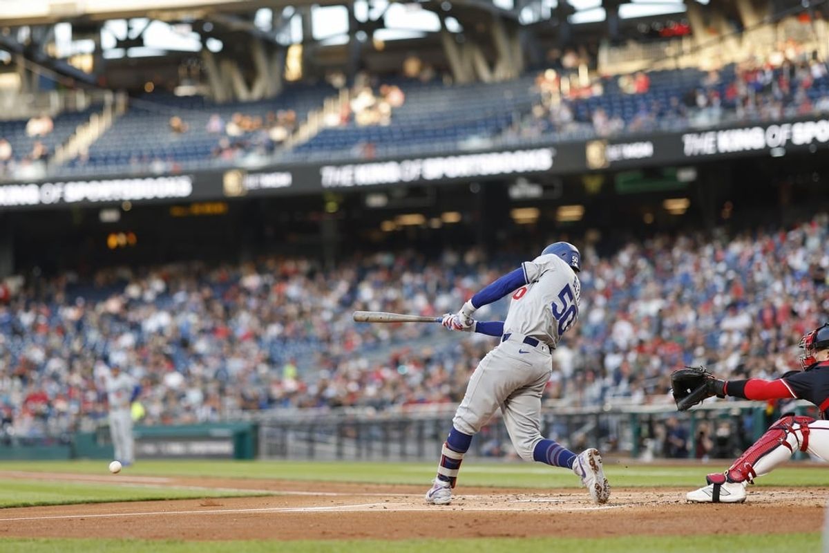 Apr 24, 2024; Washington, District of Columbia, USA; Los Angeles Dodgers shortstop Mookie Betts (50) hits a two run single against the Washington Nationals during the second inning at Nationals Park.