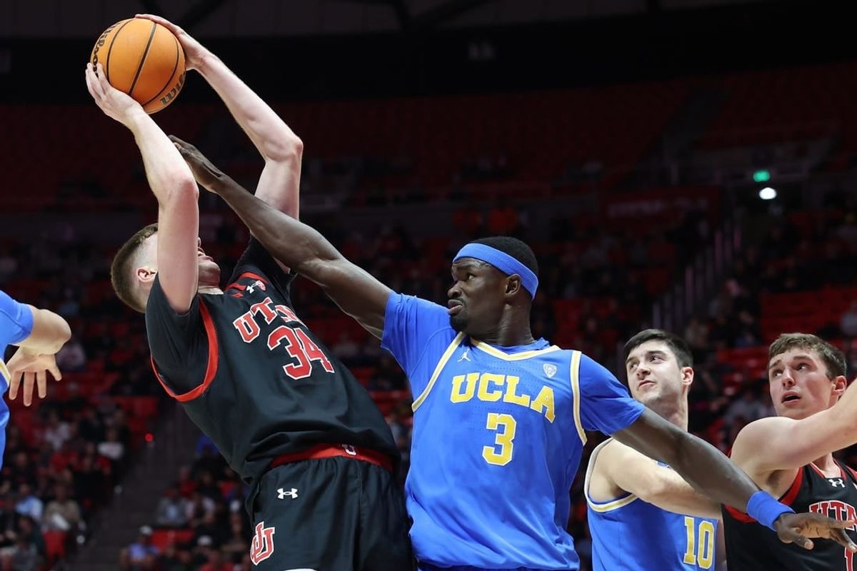 Jan 11, 2024; Salt Lake City, Utah, USA; UCLA Bruins forward Adem Bona (3) defends the shot of Utah Utes center Lawson Lovering (34) during the second half at Jon M. Huntsman Center.