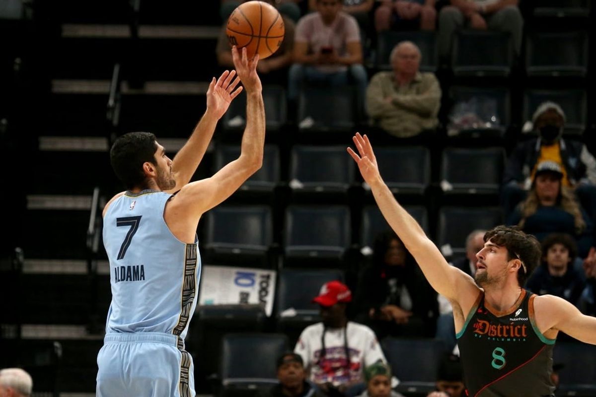 Mar 12, 2024; Memphis, Tennessee, USA; Memphis Grizzlies forward-center Santi Aldama (7) shoots for three as Washington Wizards forward Deni Avdija (8) defends during the first half at FedExForum.