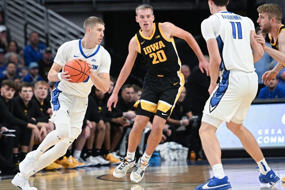 Nov 14, 2023; Omaha, Nebraska, USA; Creighton Bluejays guard Baylor Scheierman (55) drives against Iowa Hawkeyes forward Payton Sandfort (20) in the first half at CHI Health Center Omaha.