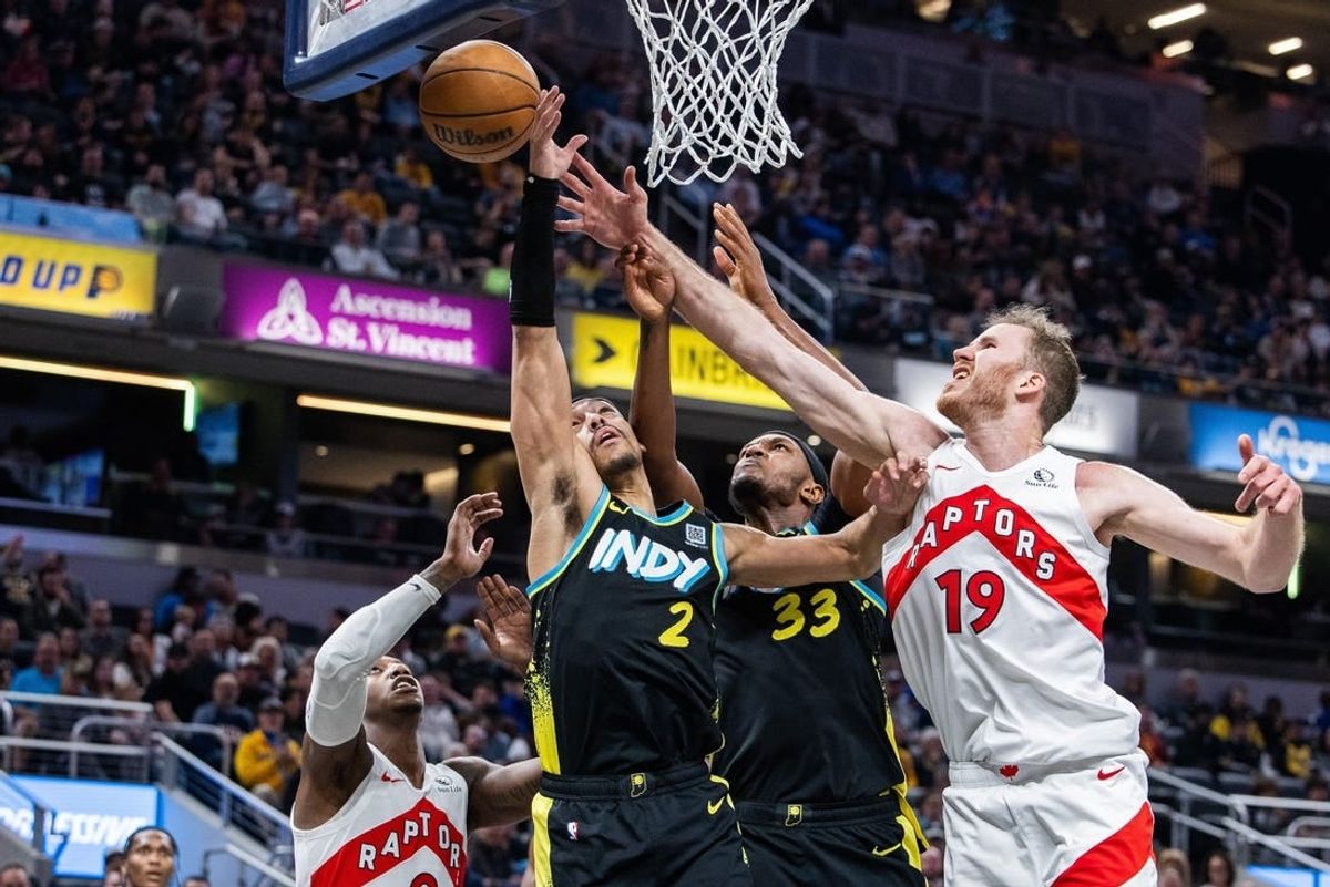 Feb 26, 2024; Indianapolis, Indiana, USA; Indiana Pacers guard Andrew Nembhard (2) shoots the ball while Toronto Raptors center Jakob Poeltl (19) defends in the second half at Gainbridge Fieldhouse.