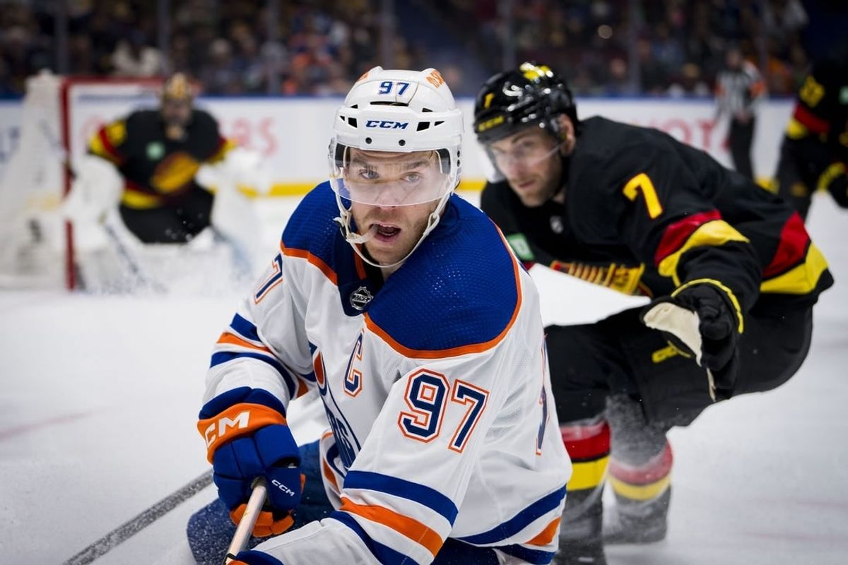 Nov 6, 2023; Vancouver, British Columbia, CAN; Vancouver Canucks defenseman Carson Soucy (7) watches as Edmonton Oilers forward Connor McDavid (97) handles the puck in the second period at Rogers Arena.