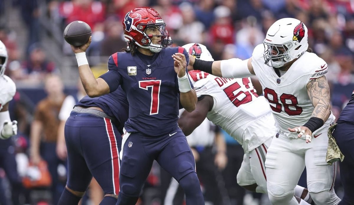 Nov 19, 2023; Houston, Texas, USA; Houston Texans quarterback C.J. Stroud (7) attempts a pass as Arizona Cardinals defensive tackle Roy Lopez (98) applies defensive pressure during the first quarter at NRG Stadium.