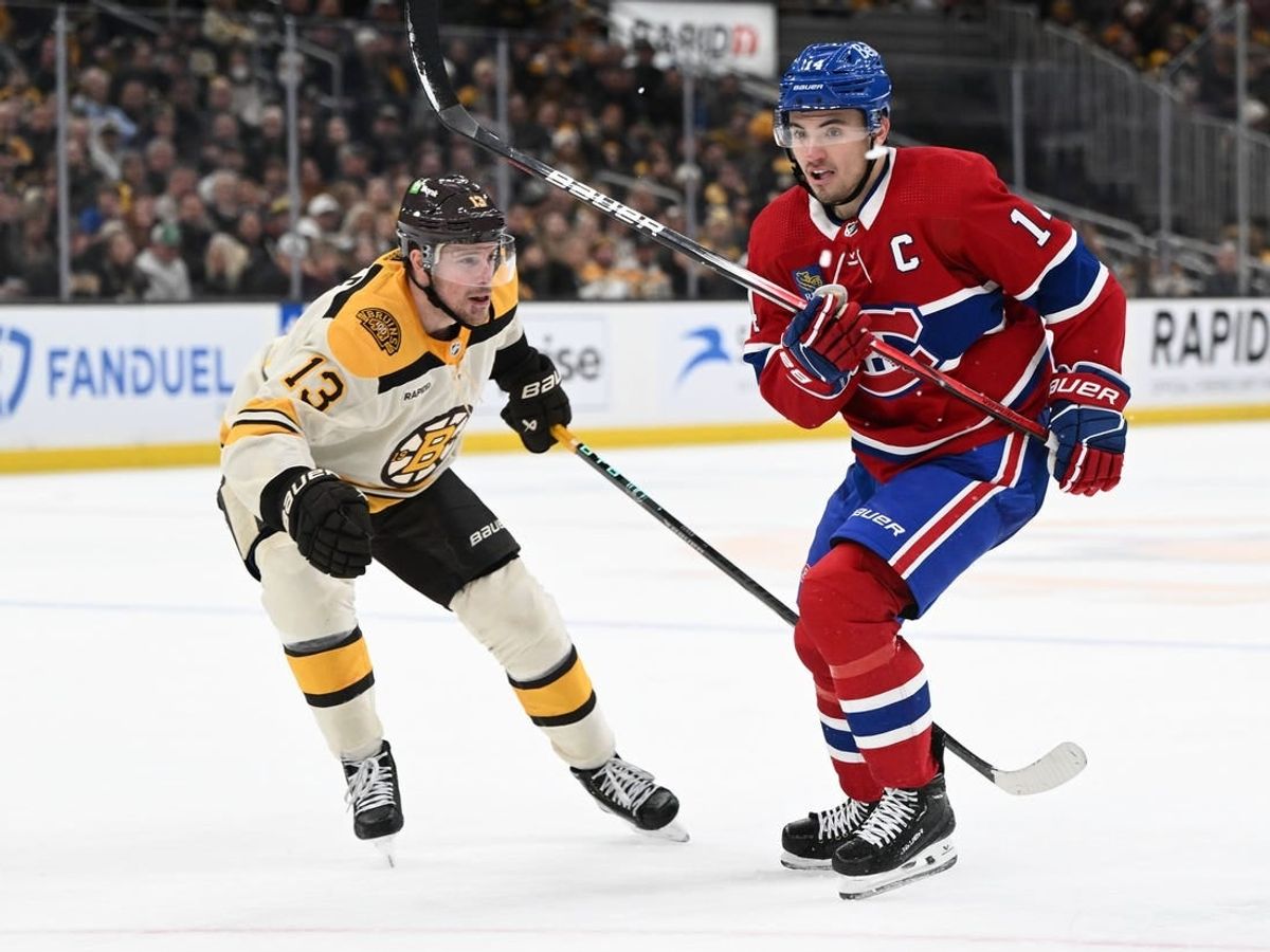 Jan 20, 2024; Boston, Massachusetts, USA; Montreal Canadiens center Nick Suzuki (14) skates against Boston Bruins center Charlie Coyle (13) during the second period at the TD Garden.