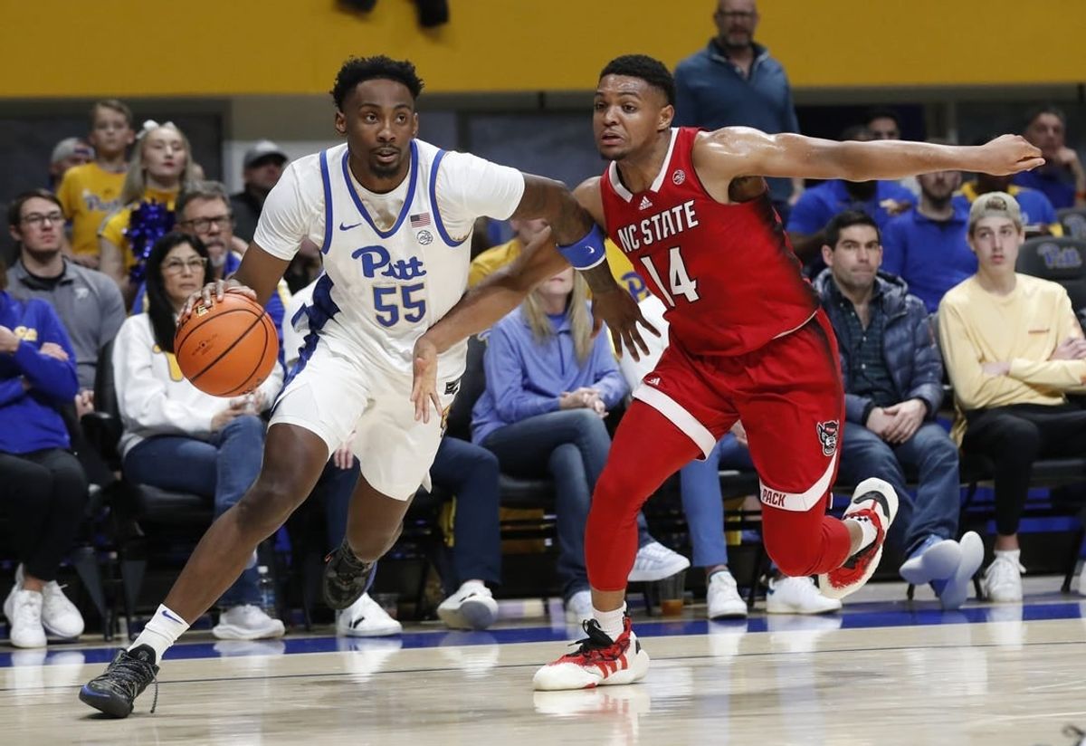 Mar 9, 2024; Pittsburgh, Pennsylvania, USA;  Pittsburgh Panthers forward Zack Austin (55) drives the baseline  against North Carolina State Wolfpack guard Casey Morsell (14) during the first half at the Petersen Events Center.