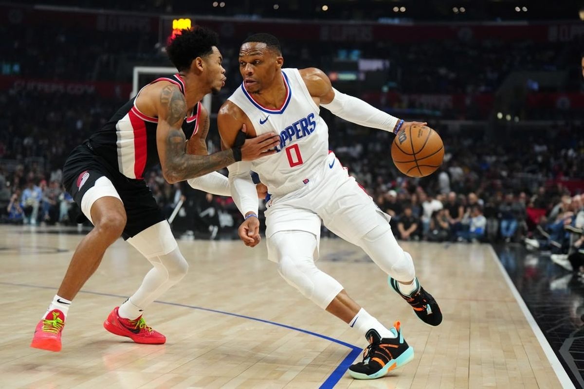 Dec 11, 2023; Los Angeles, California, USA; LA Clippers guard Russell Westbrook (0) dribbles the ball against Portland Trail Blazers guard Anfernee Simons (1) in the first half at Crypto.com Arena.