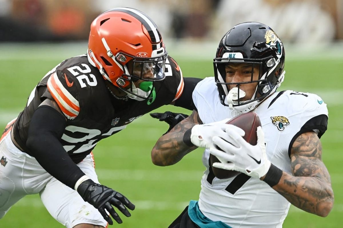 Dec 10, 2023; Cleveland, Ohio, USA; Jacksonville Jaguars tight end Evan Engram (17) catches a pass as Cleveland Browns safety Grant Delpit (22) defends during the first half at Cleveland Browns Stadium.