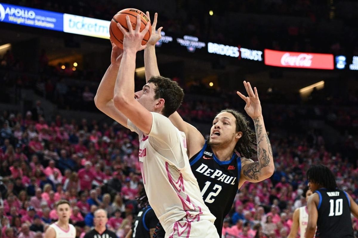 Jan 27, 2024; Omaha, Nebraska, USA; Creighton Bluejays center Ryan Kalkbrenner (11) scores against DePaul Blue Demons forward Mac Etienne (12) in the second half at CHI Health Center Omaha.