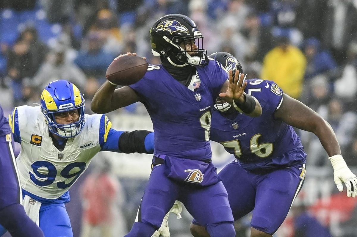Dec 10, 2023; Baltimore, Maryland, USA;  Los Angeles Rams defensive tackle Aaron Donald (99) grabs Baltimore Ravens quarterback Lamar Jackson (8) jerexzsy while he throws during the  first half at M&T Bank Stadium.