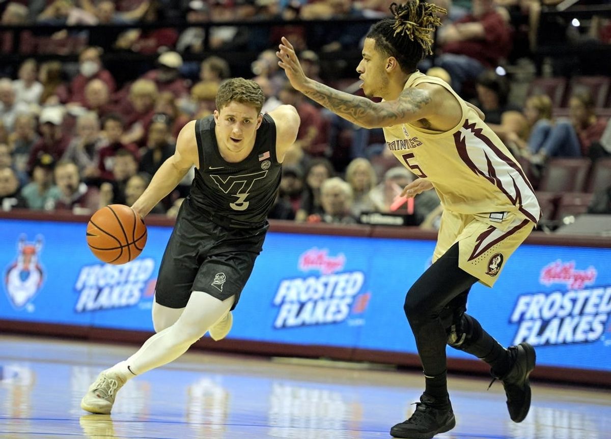 Jan 6, 2024; Tallahassee, Florida, USA; Virginia Tech Hokies guard Sean Pedulla (3) drives past Florida State Seminoles forward De Ante Green (5) during the first half at Donald L. Tucker Center.