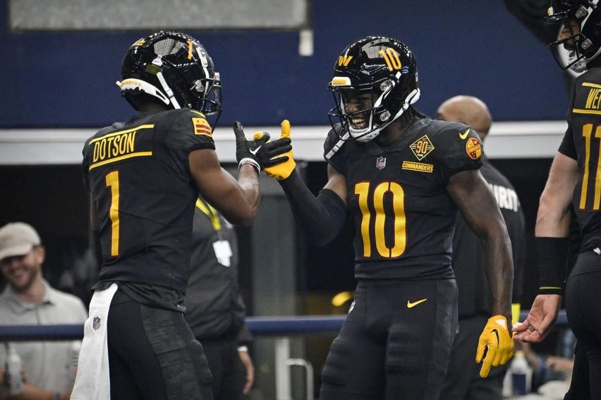 Oct 2, 2022; Arlington, Texas, USA; Washington Commanders wide receiver Jahan Dotson (1) and wide receiver Curtis Samuel (10) celebrate after Dotson catches a pass for a touchdown  against the Dallas Cowboys during the second quarter at AT&T Stadium.