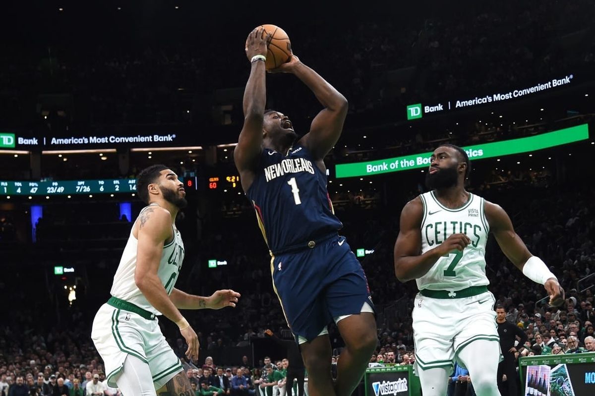 Jan 29, 2024; Boston, Massachusetts, USA;  New Orleans Pelicans forward Zion Williamson (1) shoots the ball between Boston Celtics forward Jayson Tatum (0) and guard Jaylen Brown (7) during the second half at TD Garden.