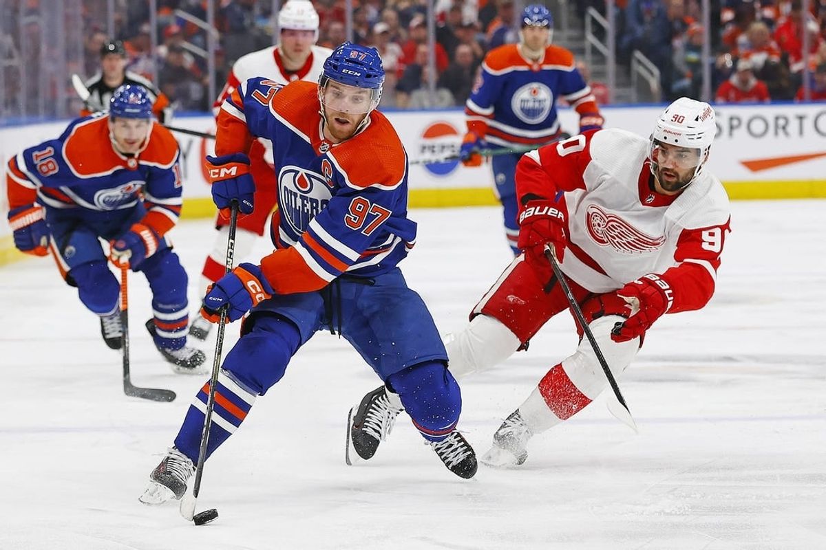 Feb 13, 2024; Edmonton, Alberta, CAN; Edmonton Oilers forward Connor McDavid (97) looks to make a pass in front of Detroit Red Wings forward Joe Veleno (90) during the third period at Rogers Place.