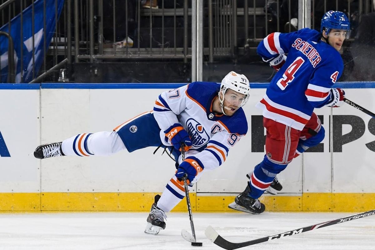 Dec 22, 2023; New York, New York, USA;  Edmonton Oilers center Connor McDavid (97) passes the puck against the New York Rangers during the third period at Madison Square Garden.