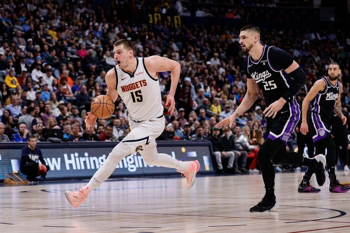 Feb 28, 2024; Denver, Colorado, USA; Denver Nuggets center Nikola Jokic (15) controls the ball ahead of Sacramento Kings center Alex Len (25) in the first quarter at Ball Arena.