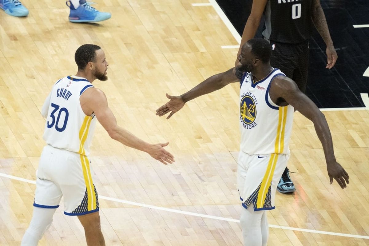April 30, 2023; Sacramento, California, USA; Golden State Warriors guard Stephen Curry (30) celebrates with forward Draymond Green (23) during the fourth quarter in game seven of the 2023 NBA playoffs first round against the Sacramento Kings at Golden 1 Center.