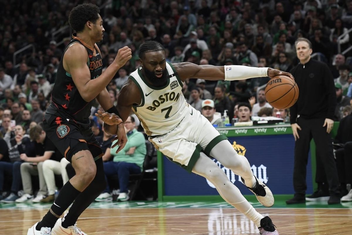 Feb 9, 2024; Boston, Massachusetts, USA; Boston Celtics guard Jaylen Brown (7) controls the ball while Washington Wizards guard Jordan Poole (13) defends during the second half at TD Garden.