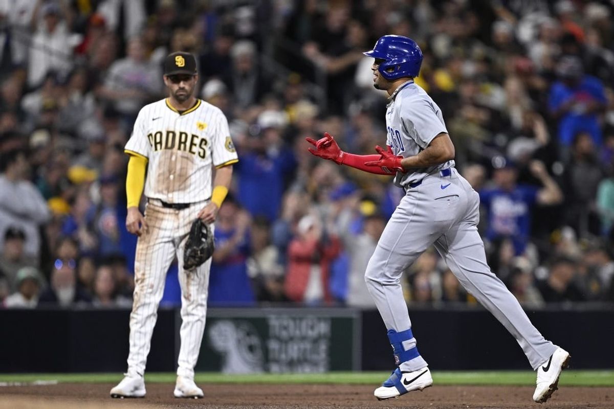 Apr 9, 2024; San Diego, California, USA; Chicago Cubs third baseman Christopher Morel (right) rounds the bases after hitting a grand slam home run as San Diego Padres third baseman Tyler Wade (14) looks on during the fifth inning at Petco Park.