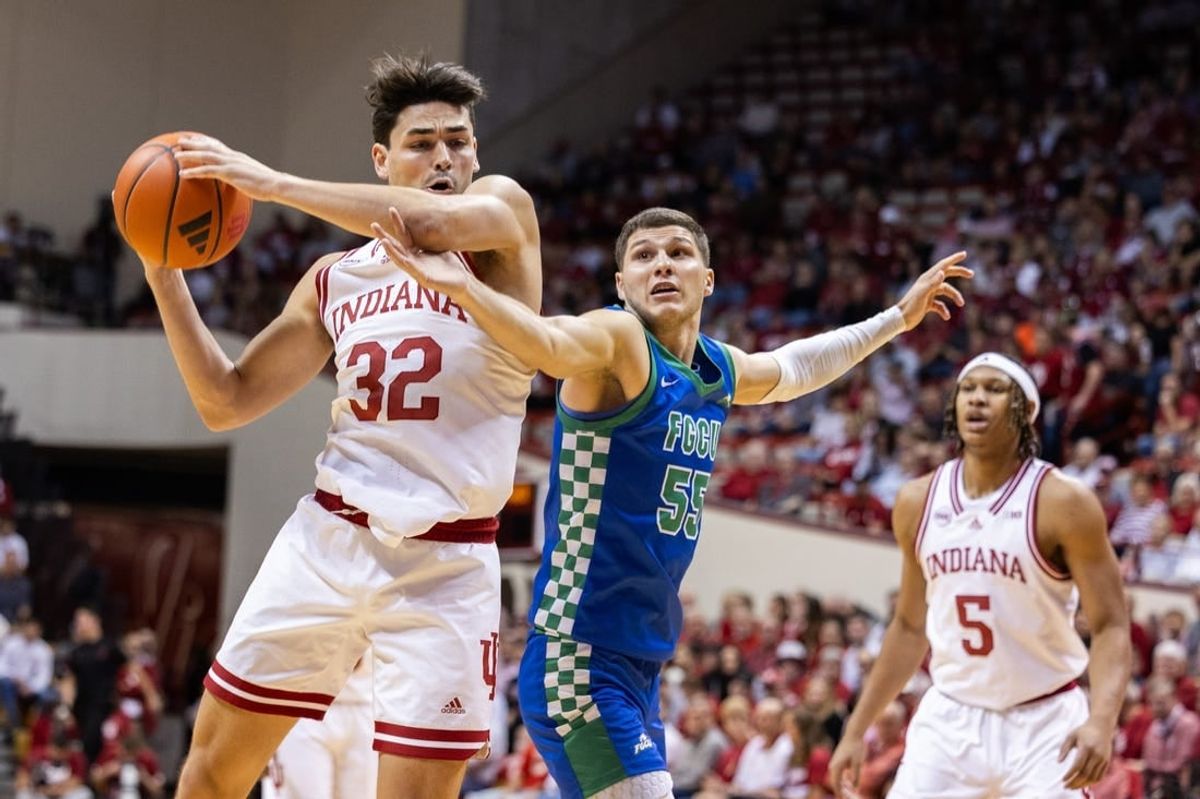 Nov 7, 2023; Bloomington, Indiana, USA; Indiana Hoosiers guard Trey Galloway (32) shoots against Florida Gulf Coast Eagles guard Chase Johnston (55) in the first half at Simon Skjodt Assembly Hall.