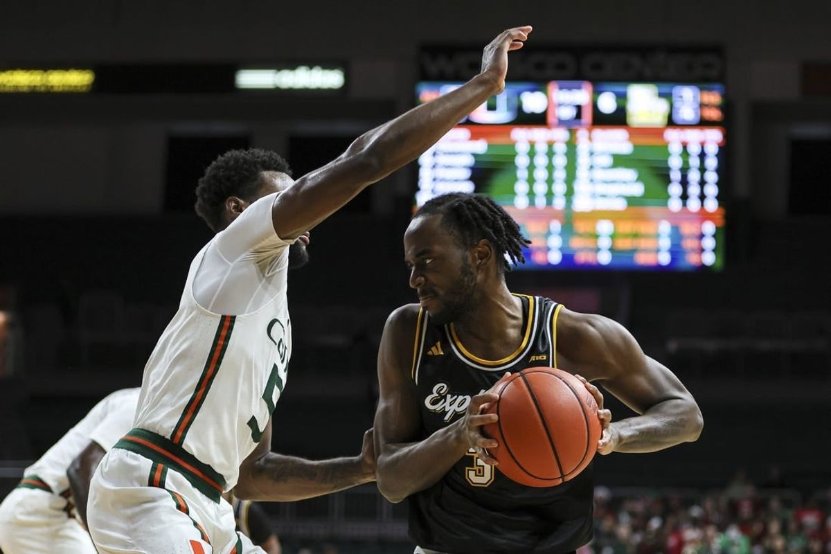 Dec 16, 2023; Coral Gables, Florida, USA; La Salle Explorers guard Anwar Gill (3) protects the basketball from Miami Hurricanes guard Wooga Poplar (5) during the first half at Watsco Center.