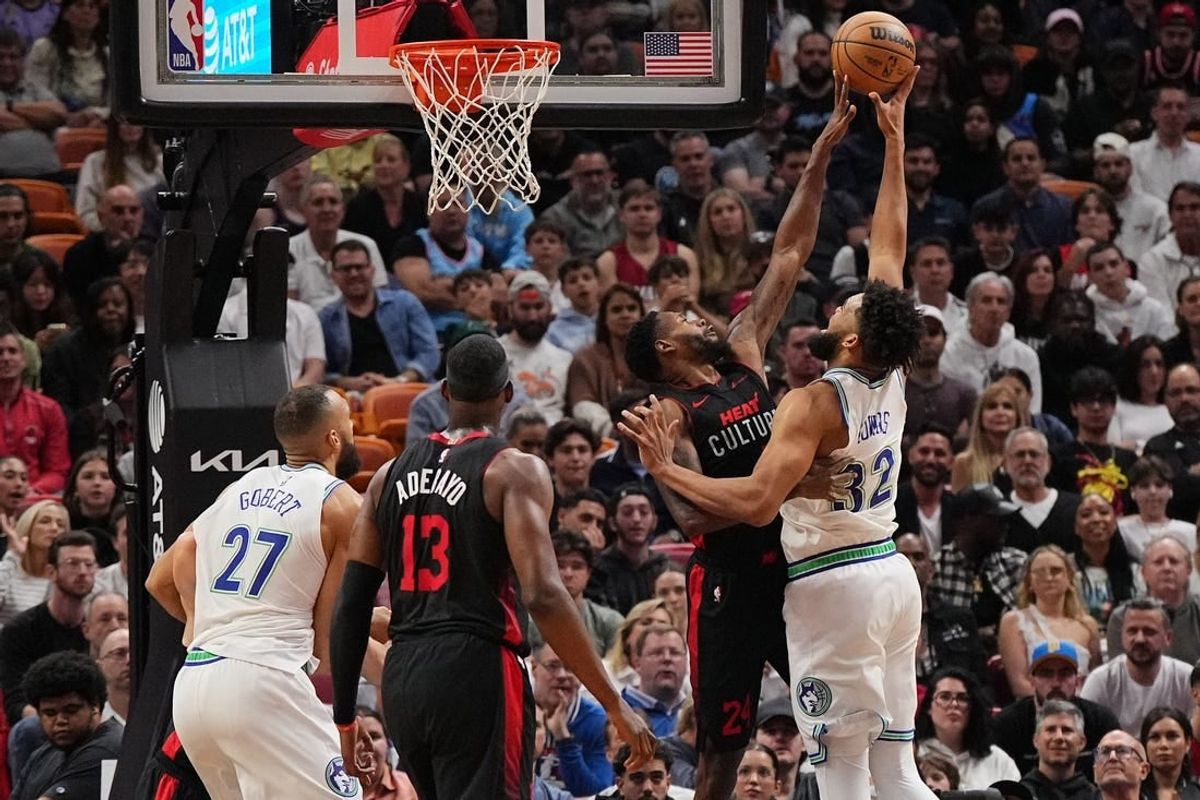Dec 18, 2023; Miami, Florida, USA; Miami Heat forward Haywood Highsmith (24) blocks the shot of Minnesota Timberwolves center Karl-Anthony Towns (32) during the first half at Kaseya Center.