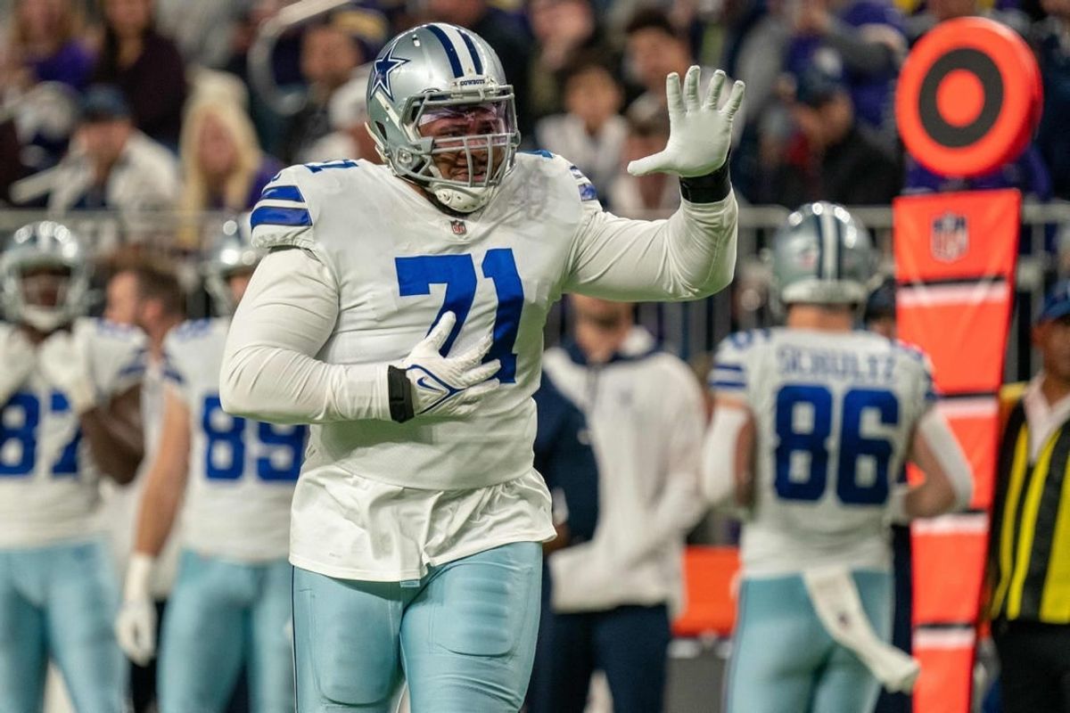 Oct 31, 2021; Minneapolis, Minnesota, USA; Dallas Cowboys offensive tackle La'el Collins (71) indicates he is an eligible receiver entering the game in the third quarter against the Minnesota Vikings at U.S. Bank Stadium.