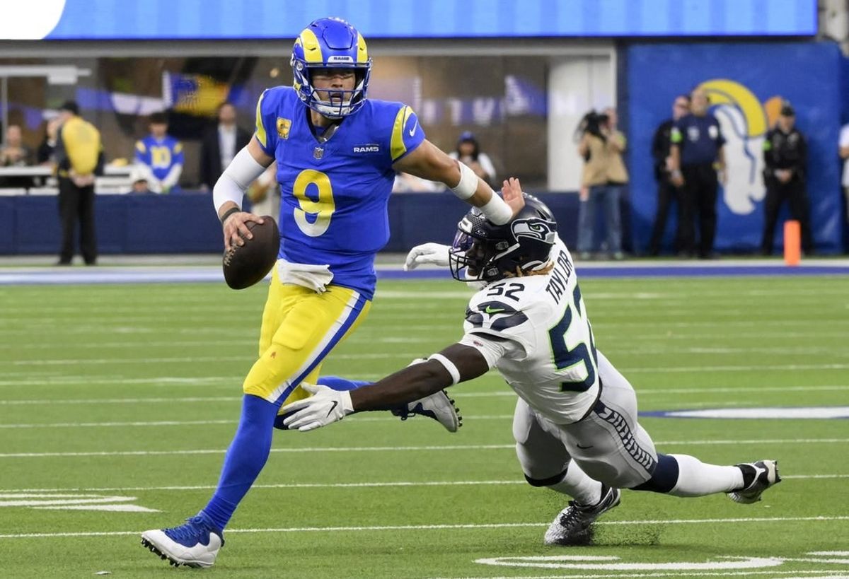 Nov 19, 2023; Inglewood, California, USA; Los Angeles Rams quarterback Matthew Stafford (9) runs against Seattle Seahawks linebacker Darrell Taylor (52) in the fourth quarter at SoFi Stadium.