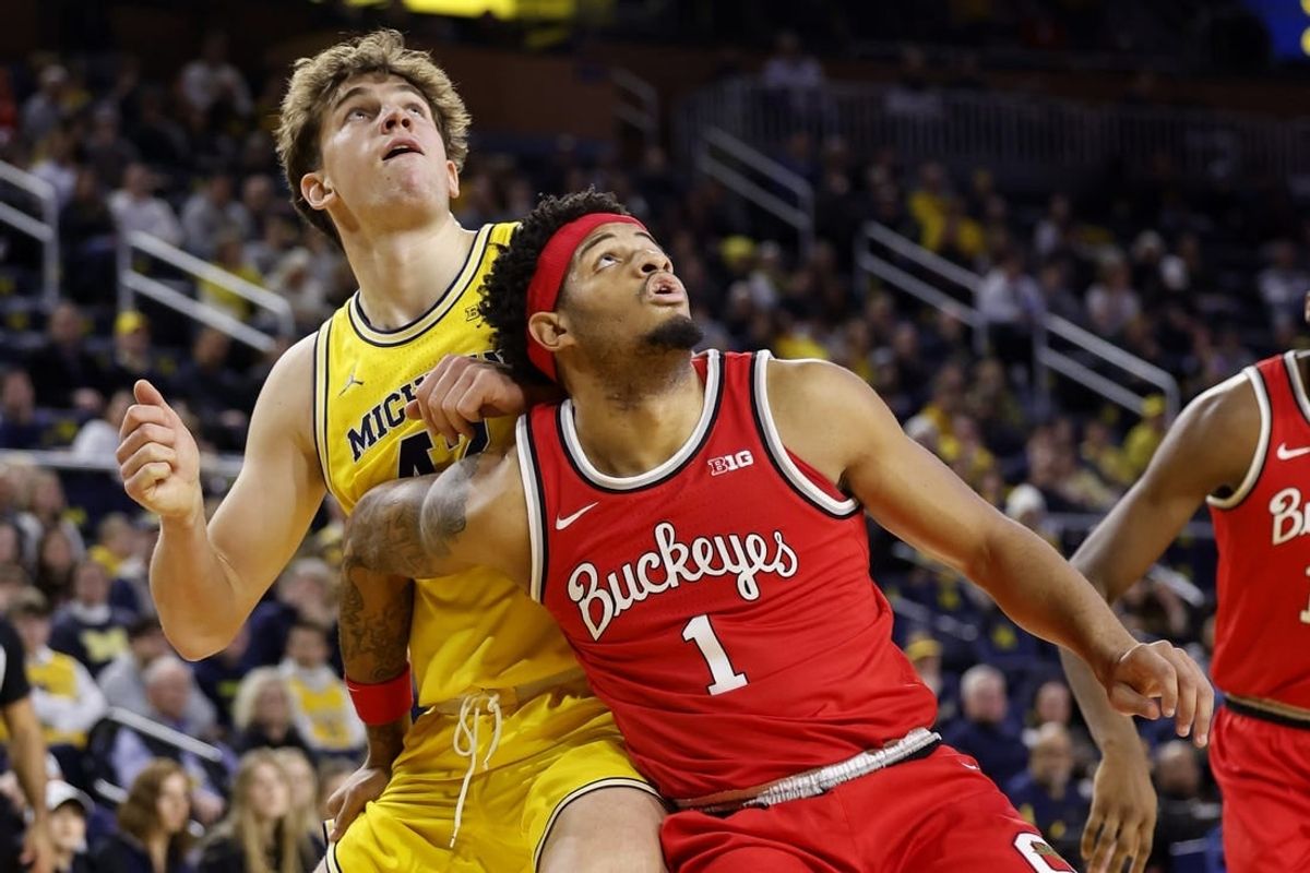 Jan 15, 2024; Ann Arbor, Michigan, USA; Michigan Wolverines forward Will Tschetter (42) and Ohio State Buckeyes guard Roddy Gayle Jr. (1) look for the rebound in the first half at Crisler Center.