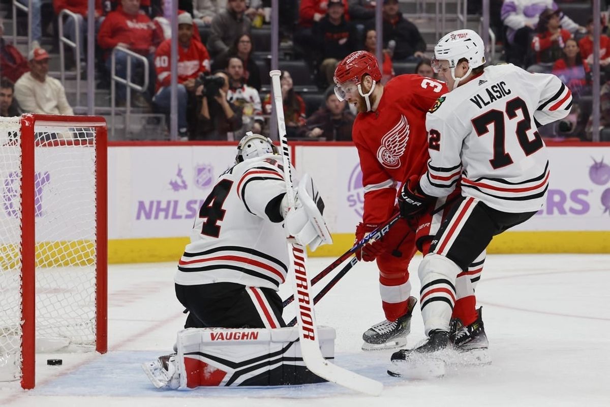 Nov 30, 2023; Detroit, Michigan, USA; Detroit Red Wings left wing J.T. Compher (37) scores a goal on Chicago Blackhawks goaltender Petr Mrazek (34) in the second period at Little Caesars Arena.