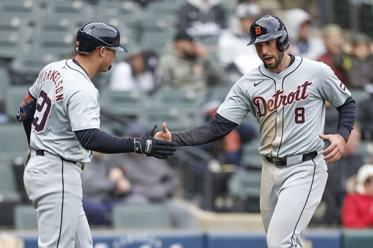 Mar 31, 2024; Chicago, Illinois, USA; Detroit Tigers right fielder Matt Vierling (8) celebrates with first baseman Spencer Torkelson (20) after scoring against the Chicago White Sox during the ninth inning at Guaranteed Rate Field.